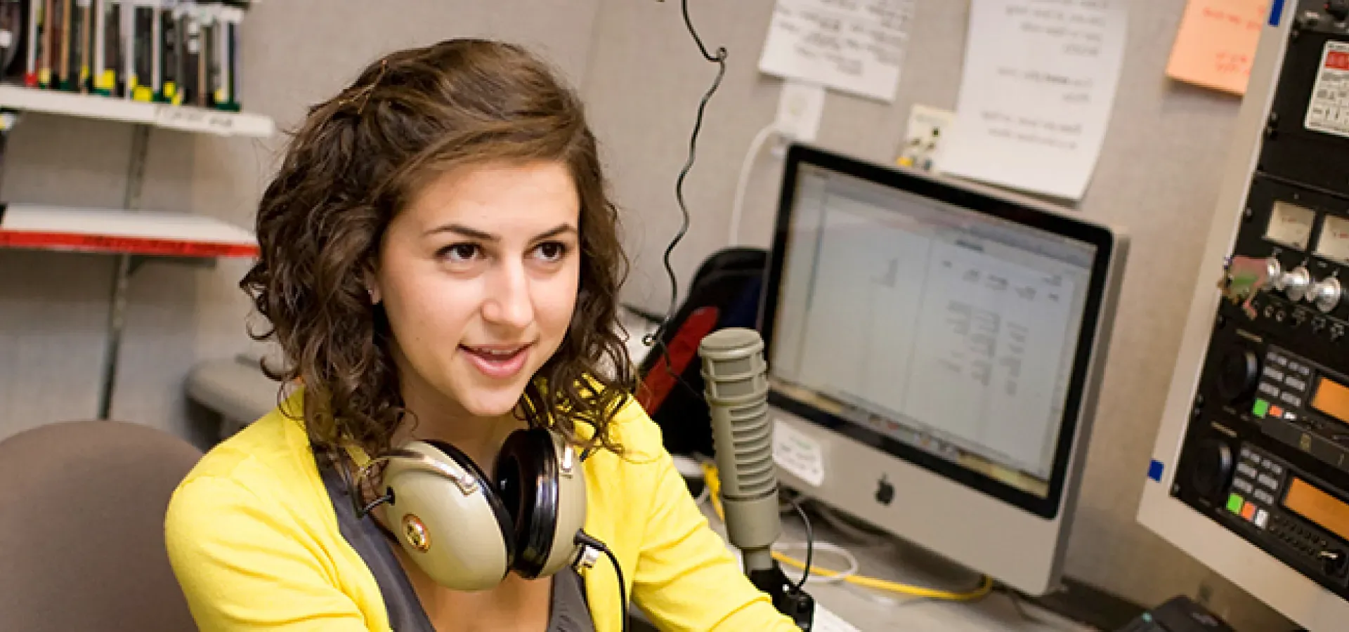 Student at the control board of the college radio station