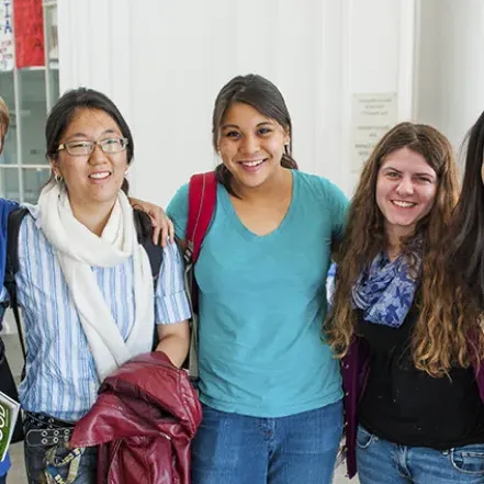 A group of smiling students posing in the Campus Center